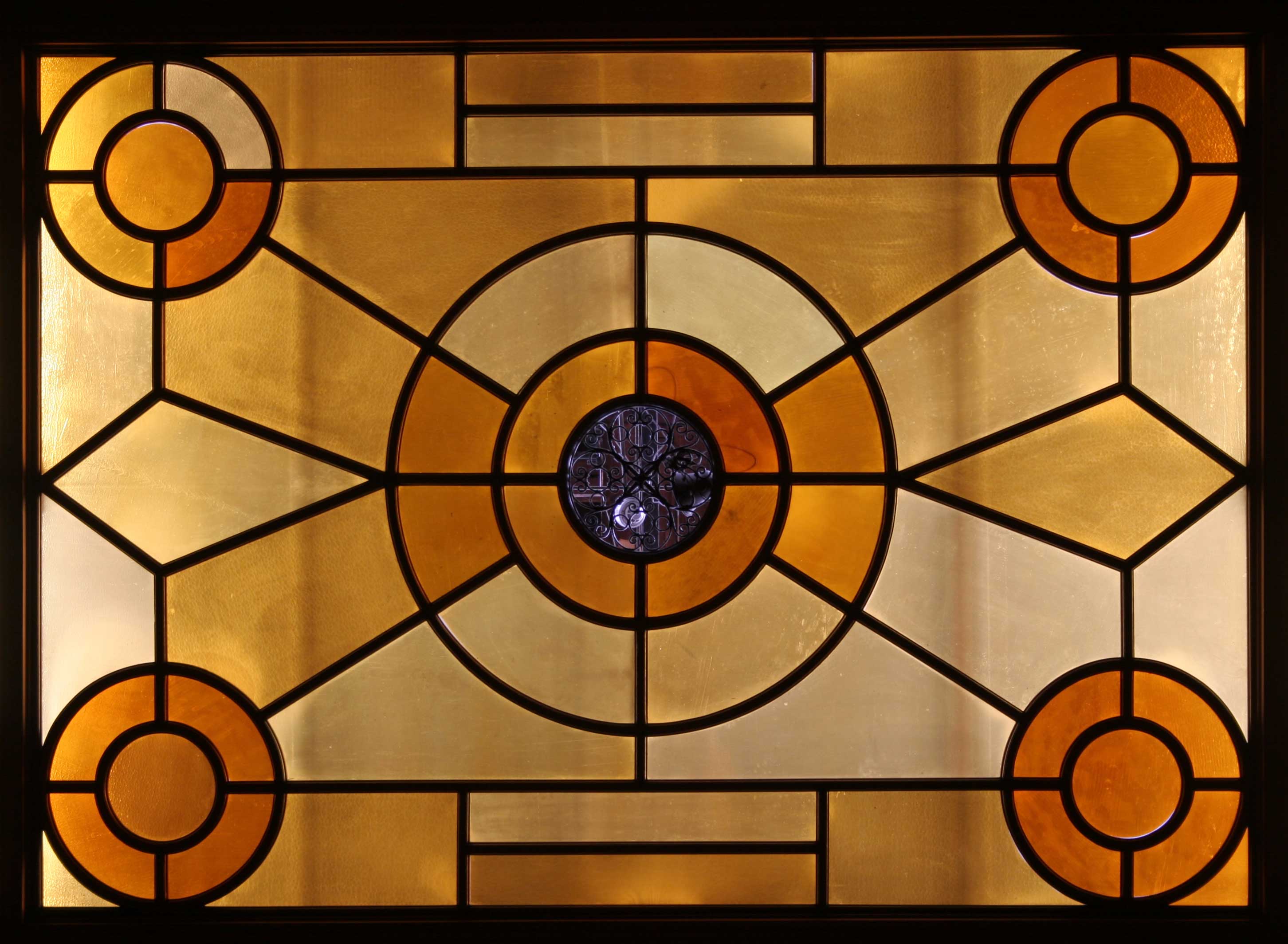 The geometric orange and yellow stained glass ceiling in the East-wing of the Legislative building. 