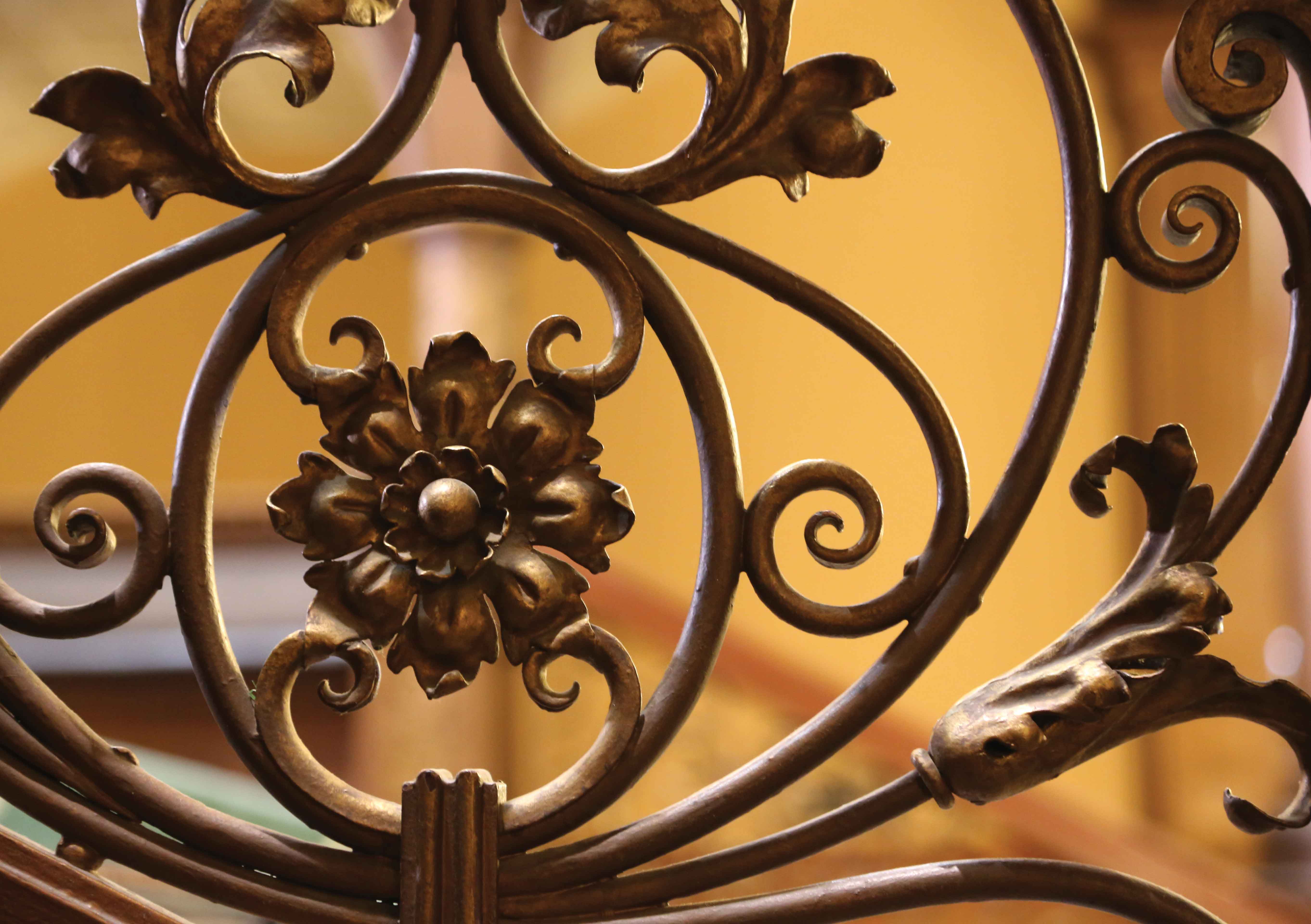 Close-up of ornate filigree details of the ironwork on the Grand staircase