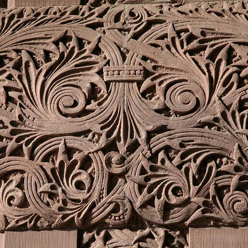 an organic and ornate pattern carved into sandstone