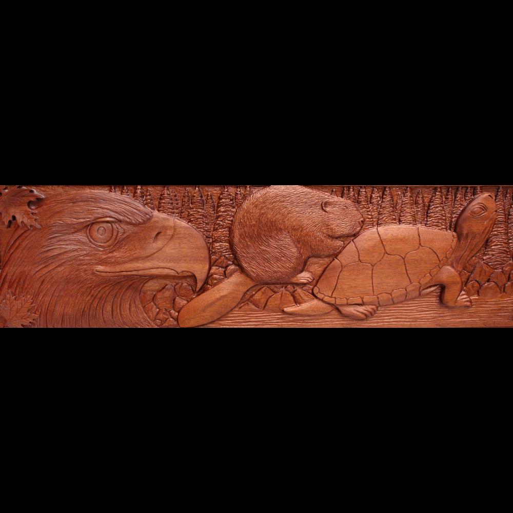 a detail of the Seven grandfather carving showing a bird, a beaver, and a turtle