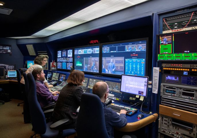 Four broadcast operators in the control room