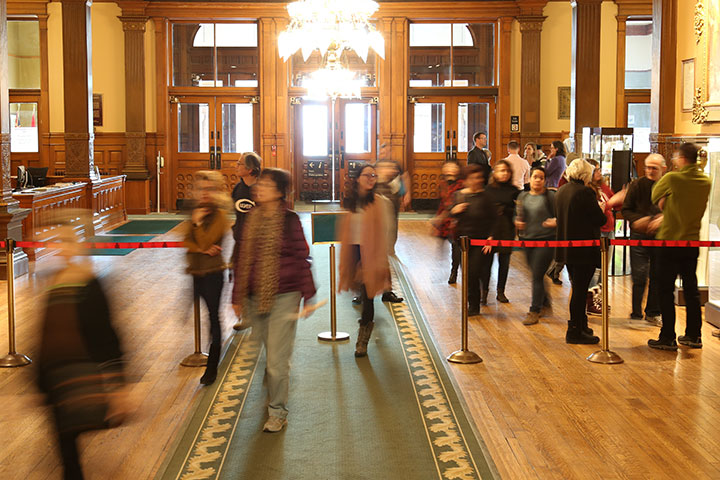 Group of people standing in the front lobby of the Legislative Building.