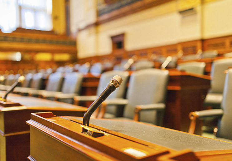 An empty seat in the front row of the Legislative Chamber