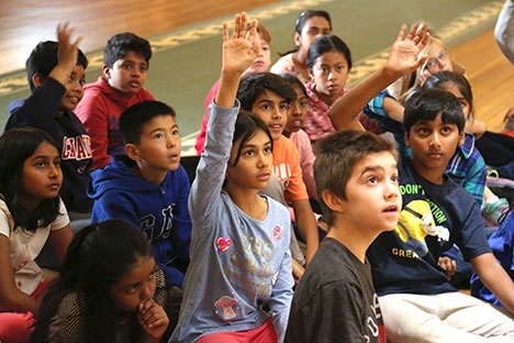 group of children with hands raised