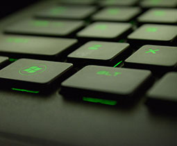 An image of a black keyboard with green buttons.