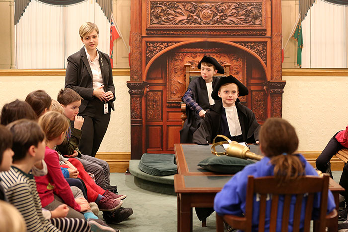 An image of children participating in a school program at the Legislative Assembly.