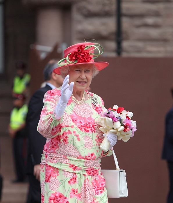 Photo of Her Majesty Queen Elizabeth II waving to the crowd outside Ontario's Legislature