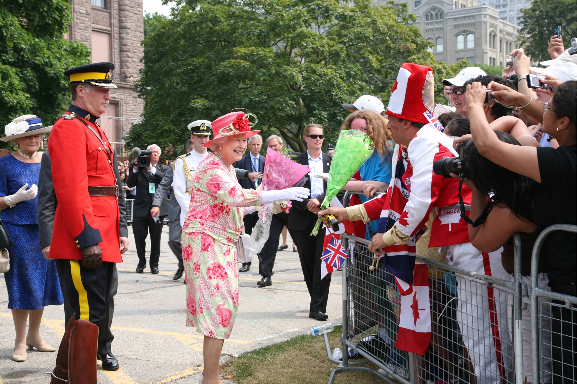 Her Majesty Queen Elizabeth II is greeted with enthusiasm by onlookers during the 2010 Royal Visit.