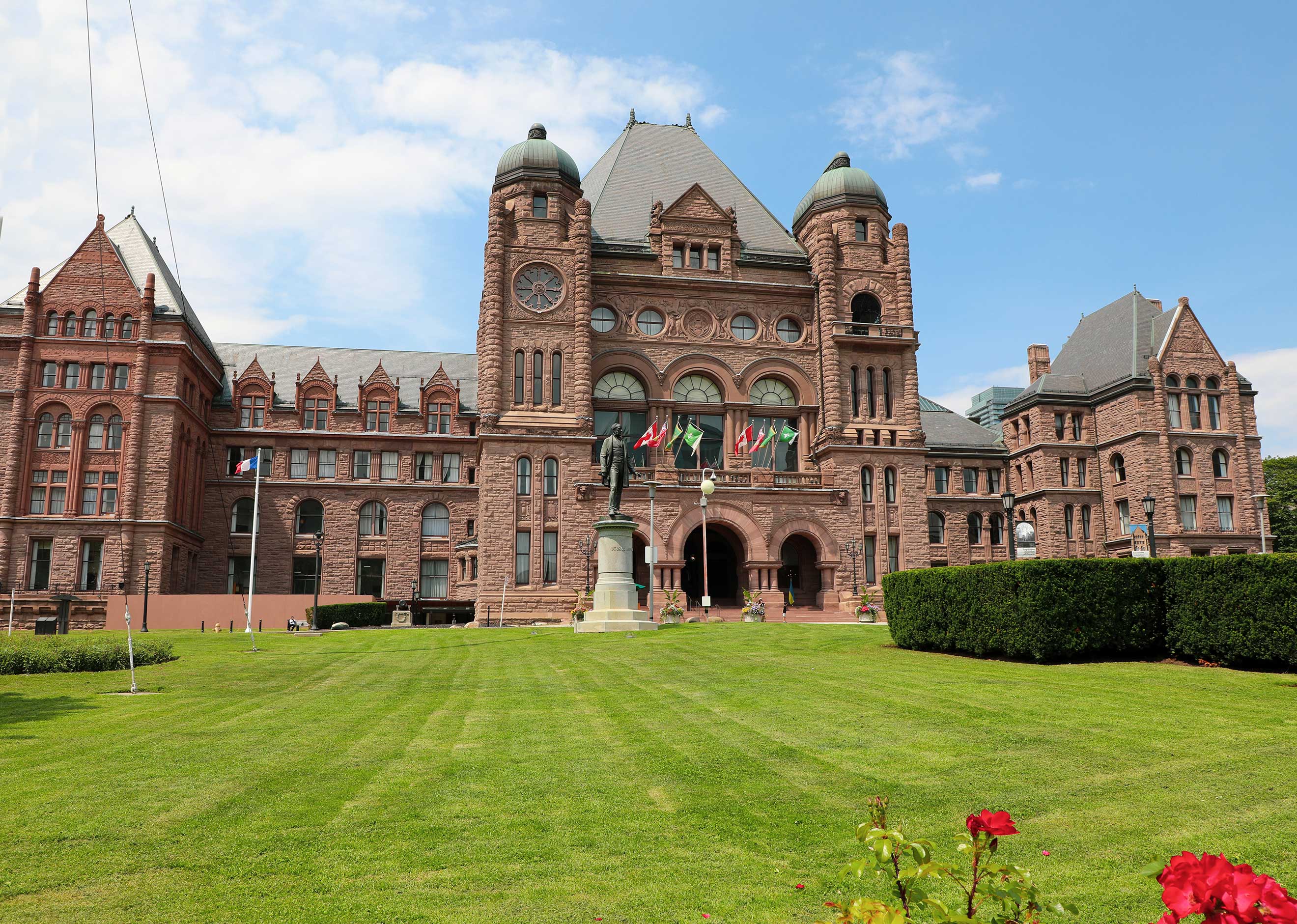 A front view of the Legislative building and green lawn in spring