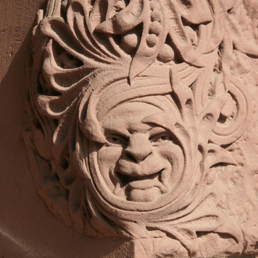 Face carved into the sandstone by the south entrance of the Legislative Building.