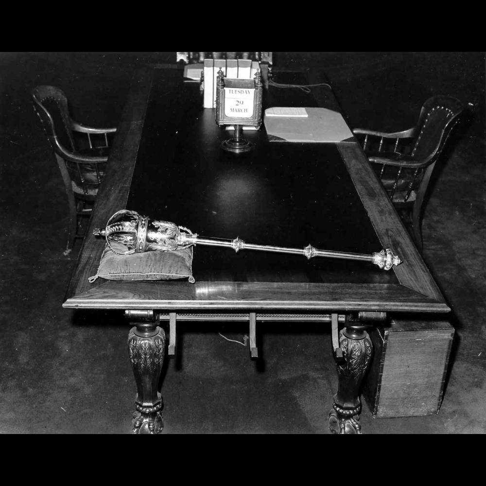 The Legislative Mace laying on the Clerk’s Table in the Chamber, circa 1960.