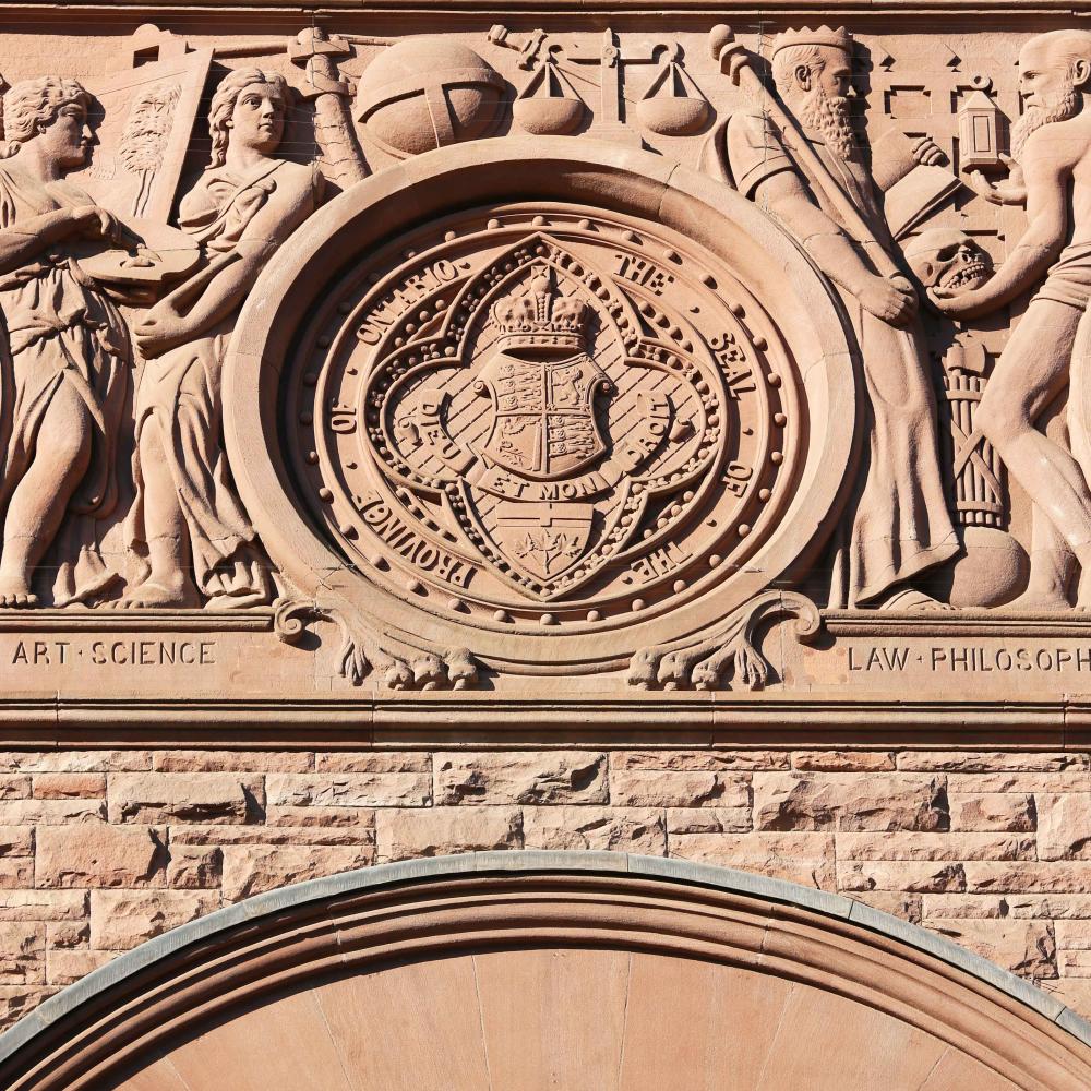 The great seal of Ontario carved in the sandstone of the exterior of the Legislative building