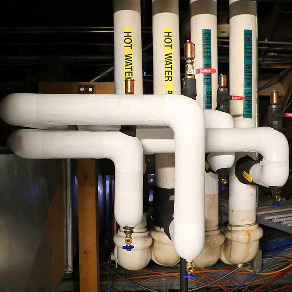 large white steam pipes in the attic of the Legislative Building