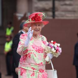 Photo of Her Majesty Queen Elizabeth II waving to the crowd outside Ontario's Legislature